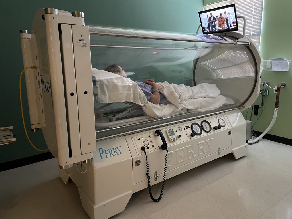 Patient inside an HBOT chamber in the Dallas Metro Area