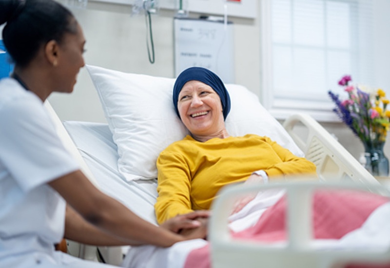 An elderly patient talking with nurse after her Radiation Treatment in Dallas Metro Area